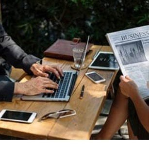Professionals at a table with laptops