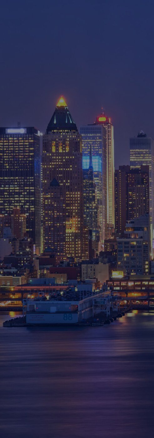 City skyline at night across the water